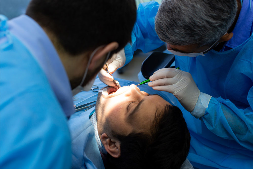 Dentist removing a patient's tooth