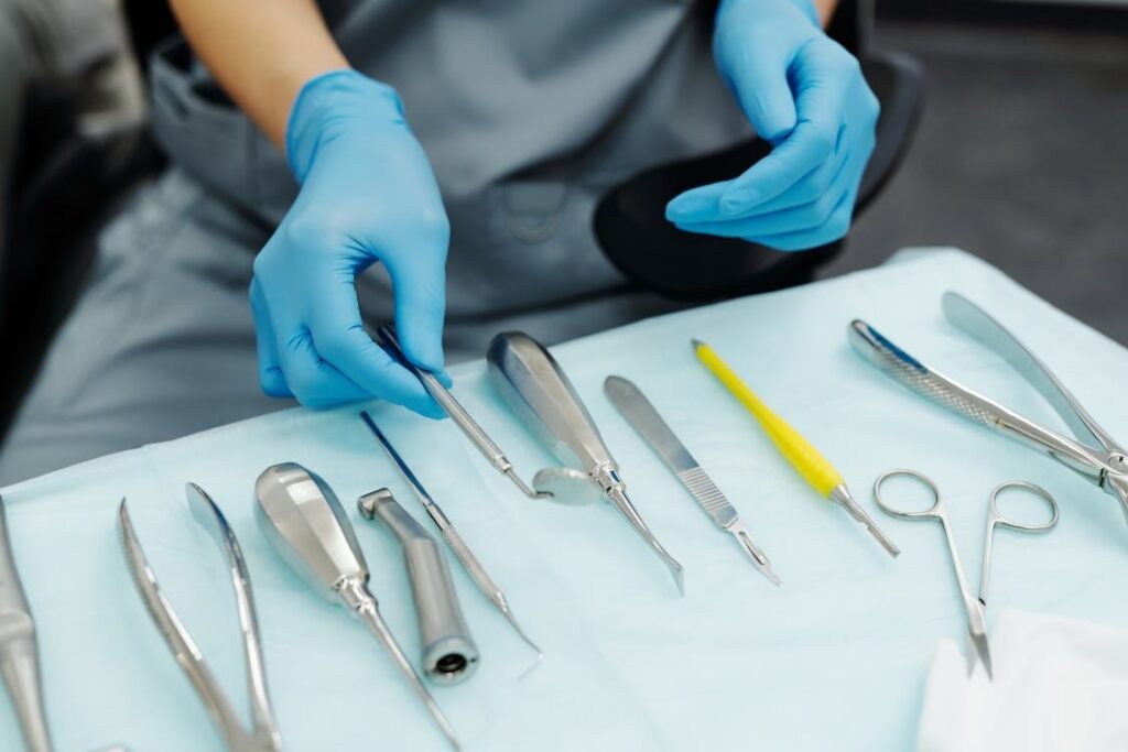 Gloved hands arranging dental tools in a Sydney clinic for wisdom teeth procedure