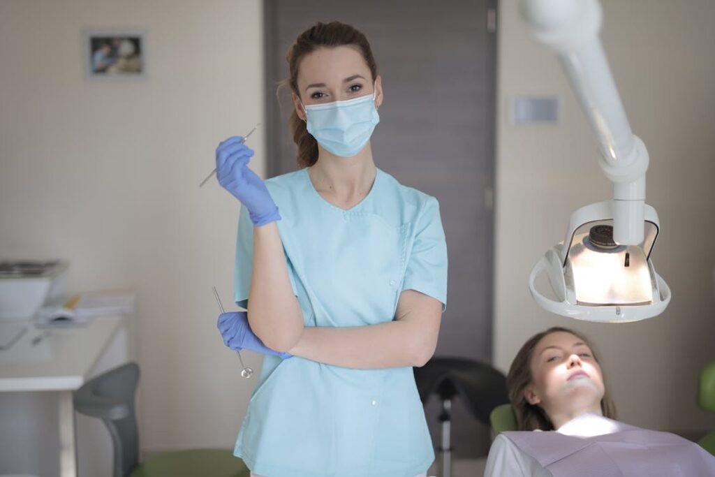 Young female dentist in Sydney holding instruments for wisdom teeth treatment