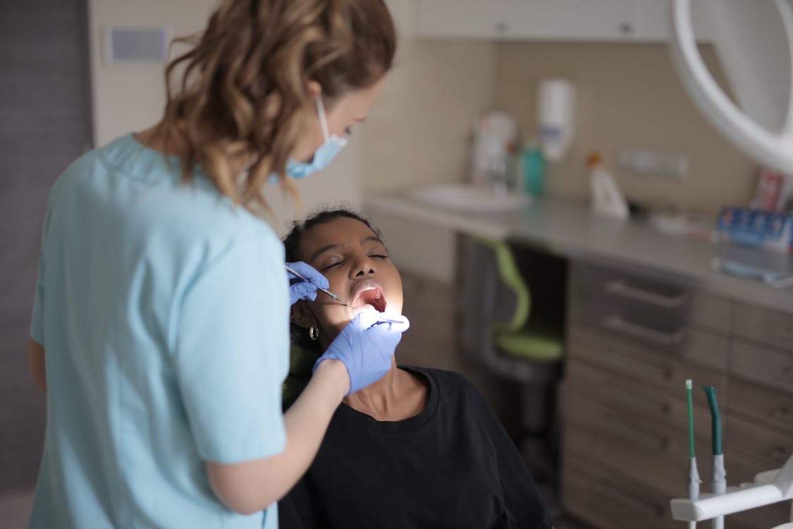 Female dentist performing wisdom teeth check-up on patient in Sydney clinic