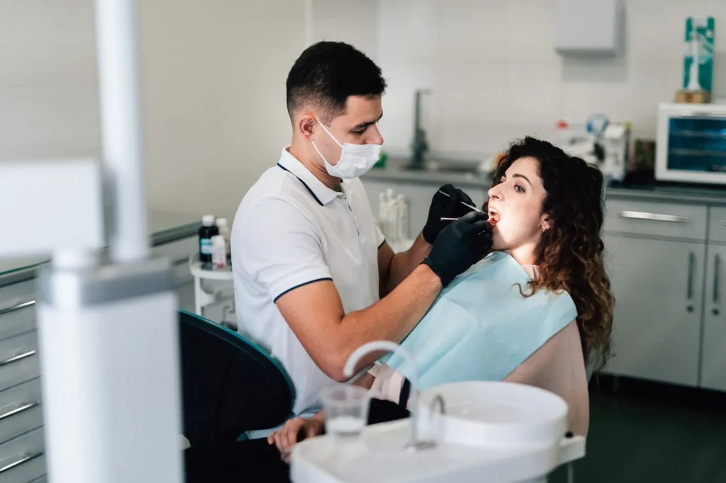 Dentist checking woman patient during Wisdom Teeth Removal Sydney consultation