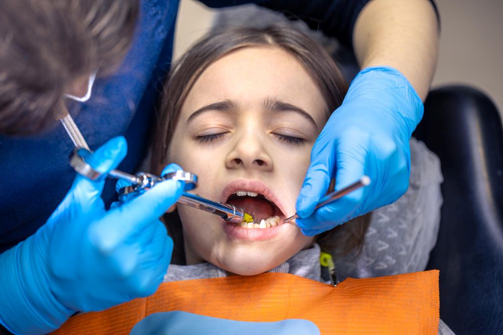 Professional dentist carrying out tooth extraction treatment