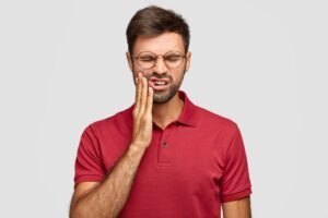 Person suffering from severe tooth pain and dental discomfort